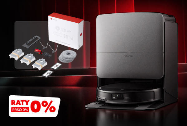 Na zdjęciu znajduje się nowoczesny odkurzacz automatyczny w stacji dokującej, a obok niego zestaw akcesoriów, w tym pudełko, szczotki, przewody i rolka. W lewym dolnym rogu widnieje napis RATY RRSO 0%.